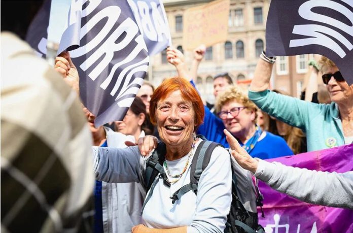 elderly-woman-with-red-hair-amidst-abortion-rights-protest-in-amsterdam-dam-square