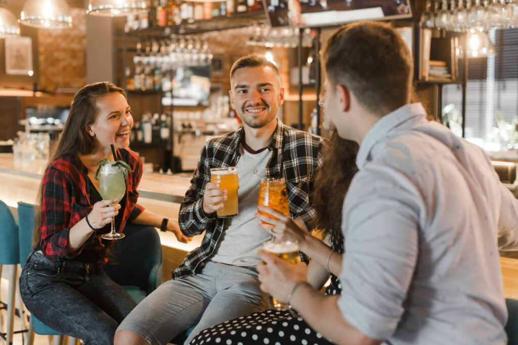 Group-of-friends-sitting-at-a-bar-having-drinks