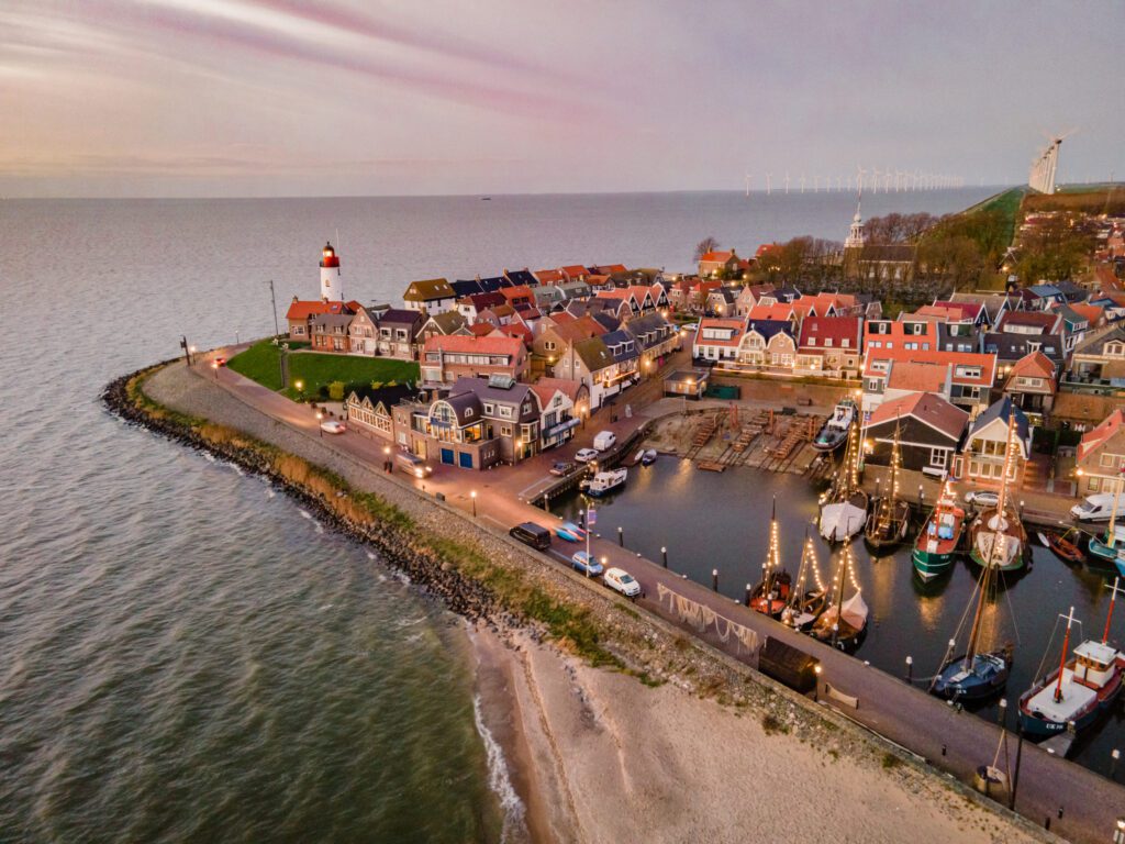 Harbor with the lighthouse on a bright summer in the Netherlands at the historical village of Urk in the Dutch Bible Belt