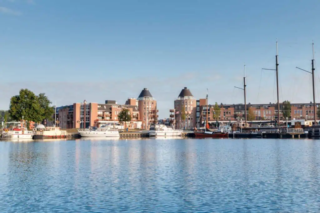 photo-of-almere-haven-taken-from-across-the-water-with-two-towers-and-buildings-on-horizon