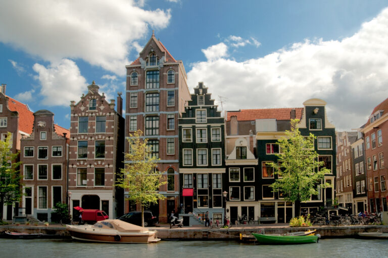 amsterdam-canal-houses-with-blue-skies-the-netherlands