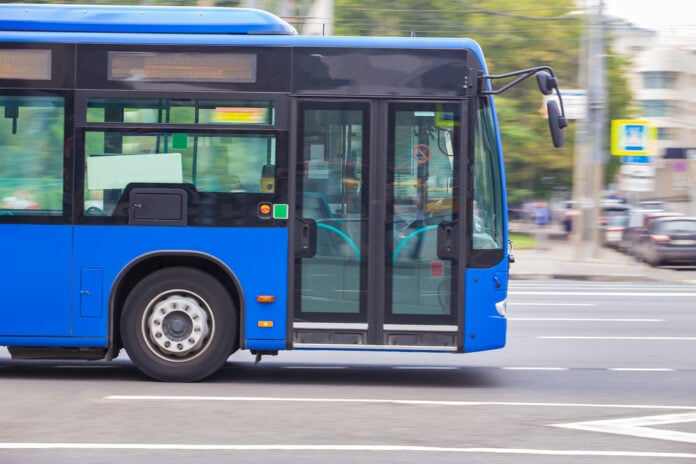 pgoto-of-blue-bus-zooming-from-left-side-of-frame-to-right-on-city-street-in-the-netherlands