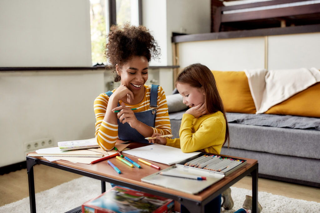 babysitter-in-the-netherlands-taking-care-of-little-girl-in-living-room-as-dutch-childcare-costs-reduce