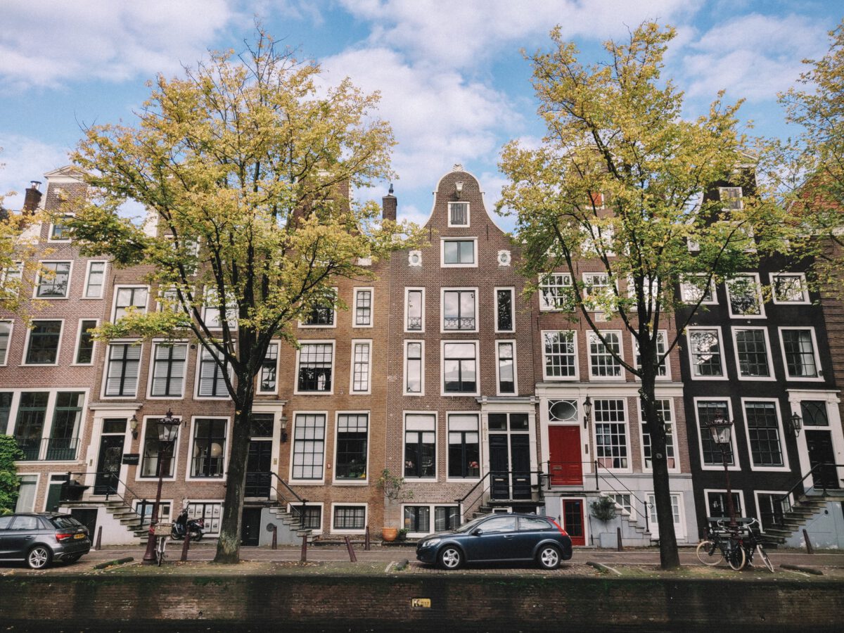 Photo-of-Amsterdam-canal-houses-with-car-parked-in-front