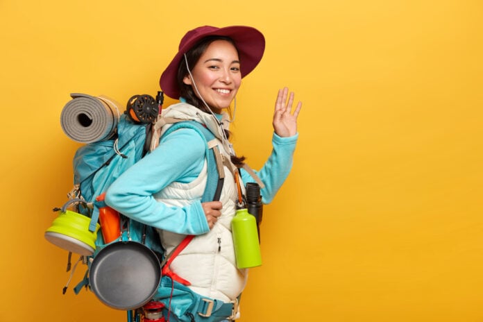 photo-of-woman-with-fully-loaded-backpack-smiling