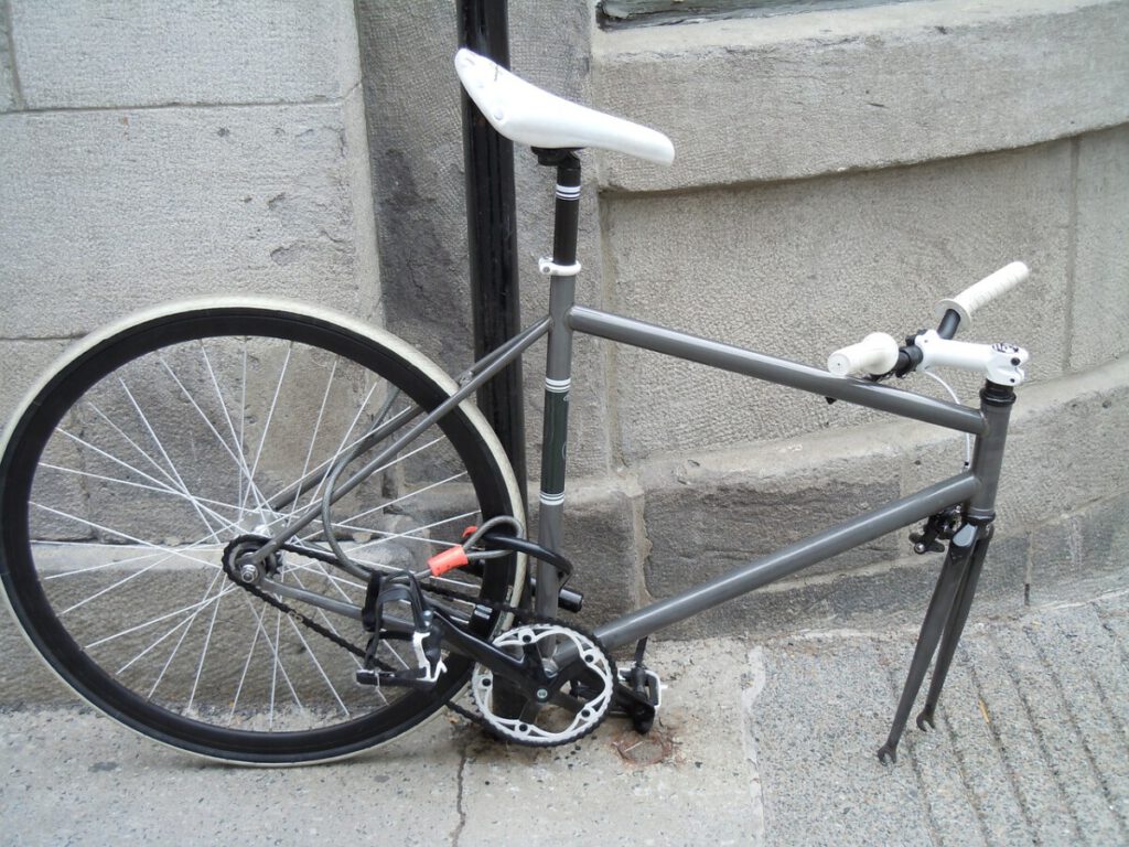 Image-of-a-broken-bicycle-chained-to-a-light-post