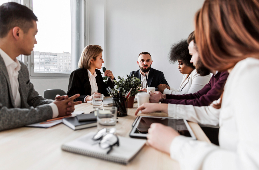 photo-of-boardroom-meeting-with-experts-discussing-around-table