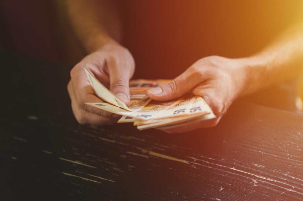 photo-of-man-with-a-stack-of-money