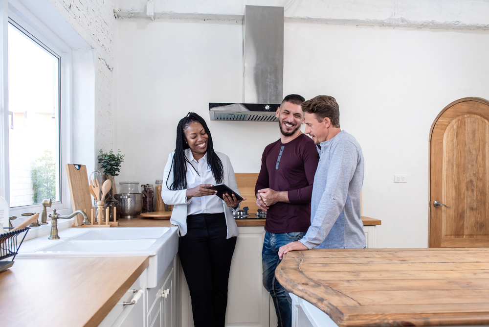 Photo-of-couple-and-realtor-talking-after-making-an-offer-on-a-Dutch-house