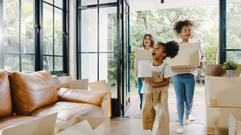 photo-of-family-running-into-house-they-just-bought-in-the-netherlands-with-boxes