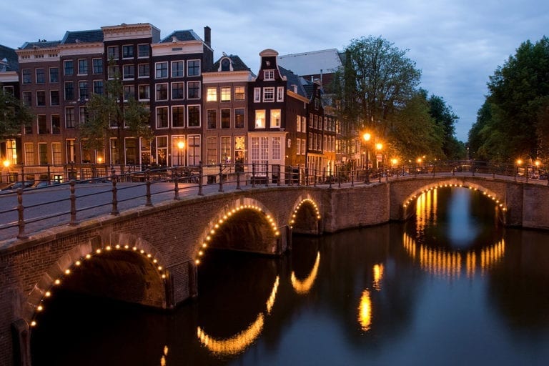 view-of-cultural-heritage-site-amsterdam-canals-at-night-with-lights-top-dutch-cultural-monuments-netherlands