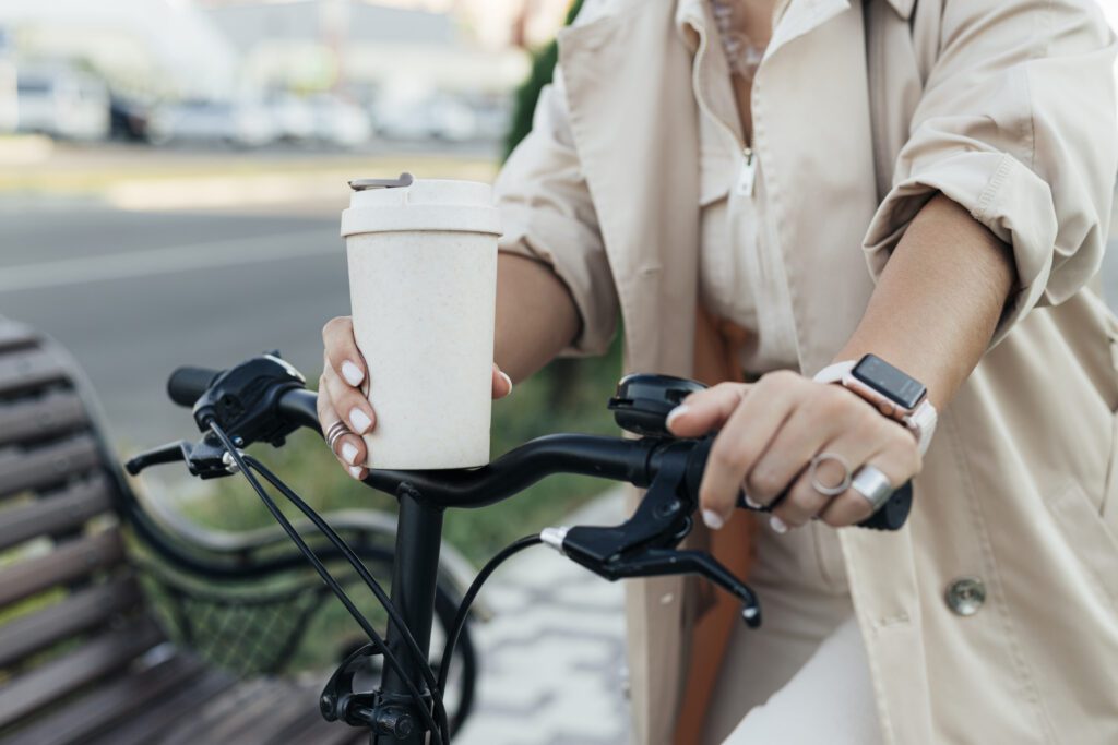 casual-woman-riding-bike-while-holding-coffe-with-bike-insurance-in-the-netherlands