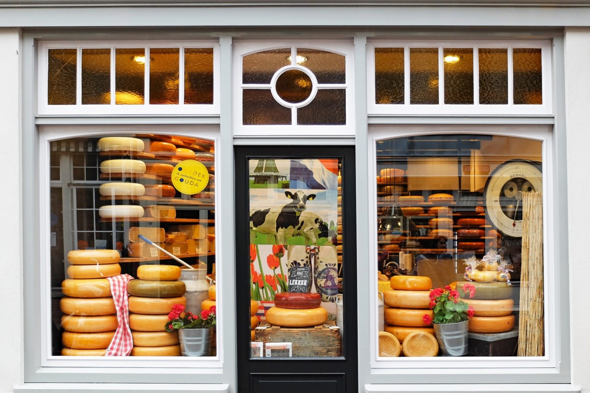 photo-of-wheels-of-gouda-cheese-seen-through-window-of-cheese-shop-in-the-netherlands