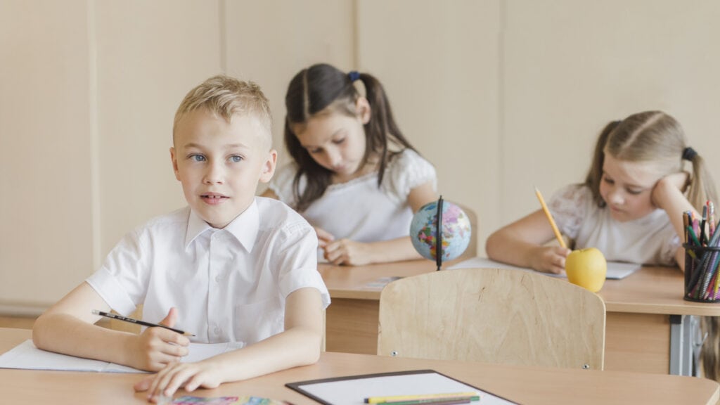 children-at-an-international-school-in-the-netherlands-writing-in-their-schoolbooks