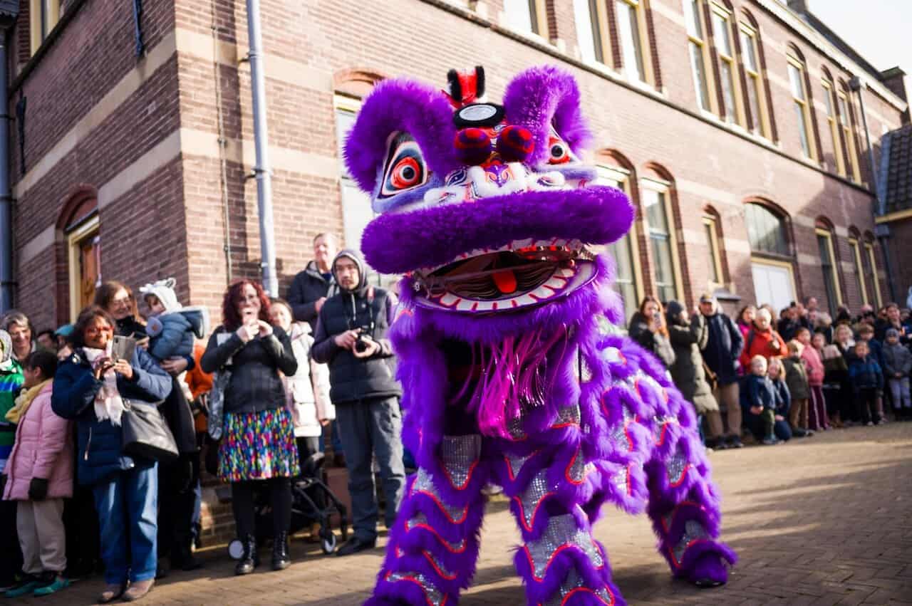 photo-of-chinese-new-year-celebration-taking-place-at-wereldmuseum-leiden-with-dancing-dragon-and-crowd-in-background