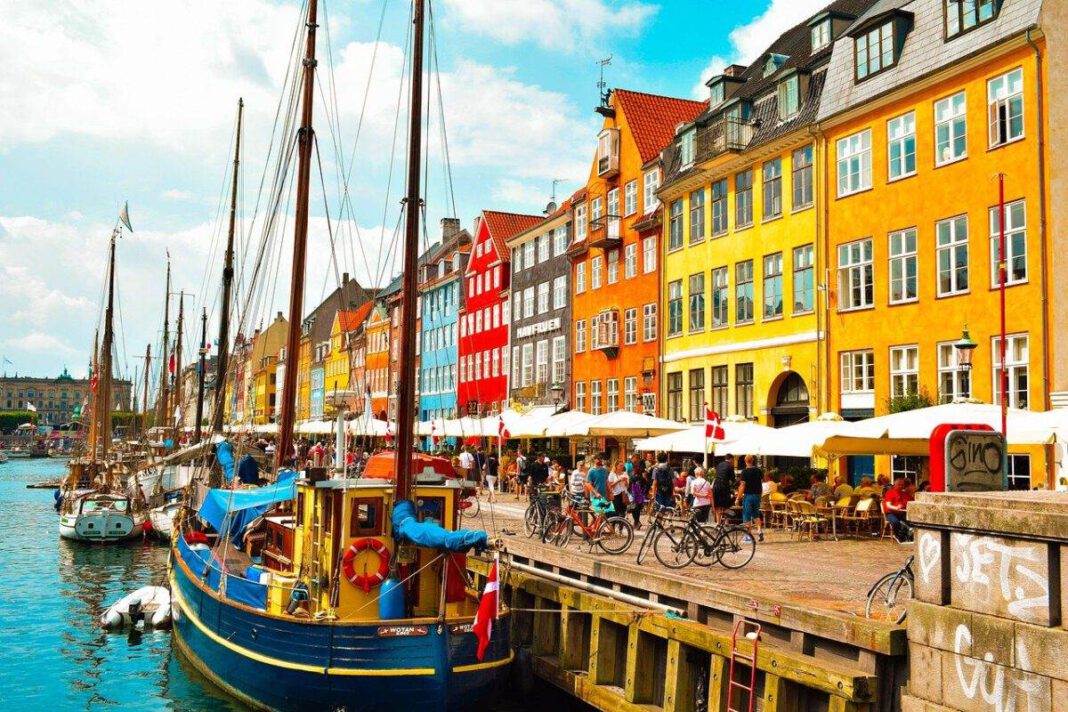 People enjoying summer holidays at cafe in Copenhagen