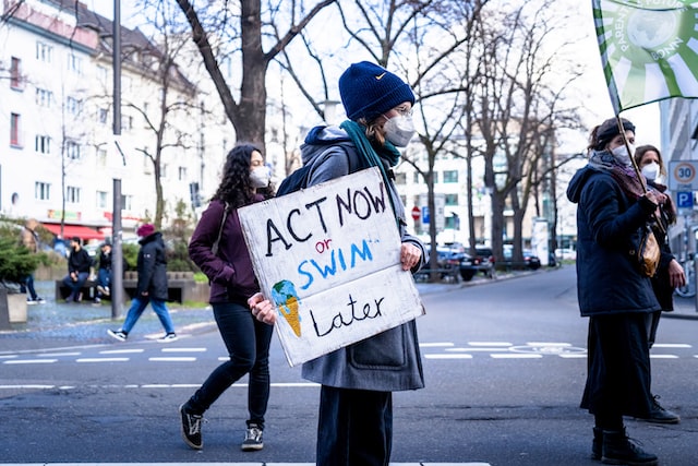 person-holding-climate-change-sign-at-protest