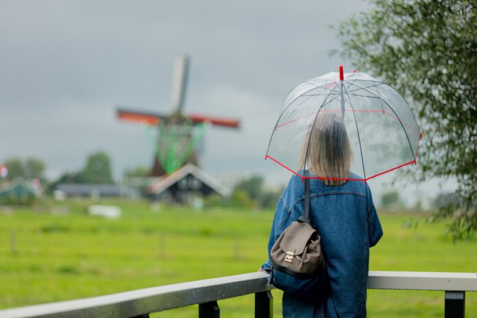 photo-of-woman-with-umbrella-in-cloudy-dutch-weather