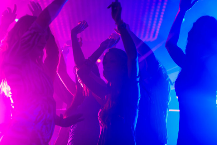 Shapes-of-women-dancing-in-nightclubs-with-blue-and-purple-lights