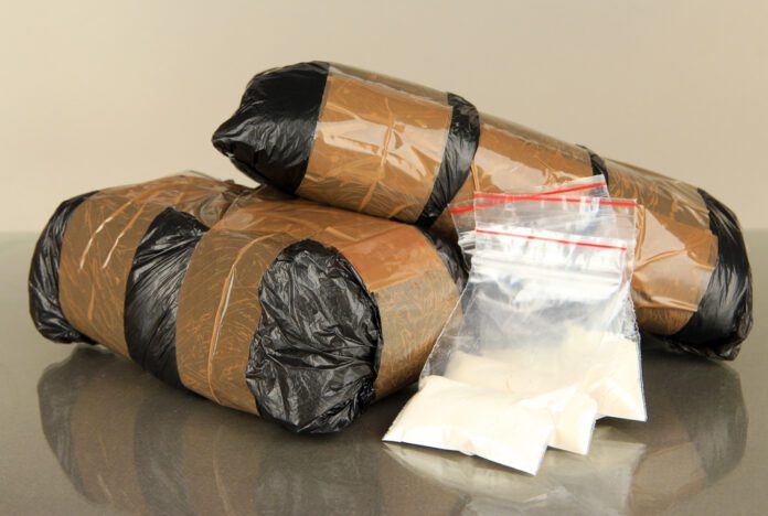 packages-of-drugs-in-bags-on-grey-background