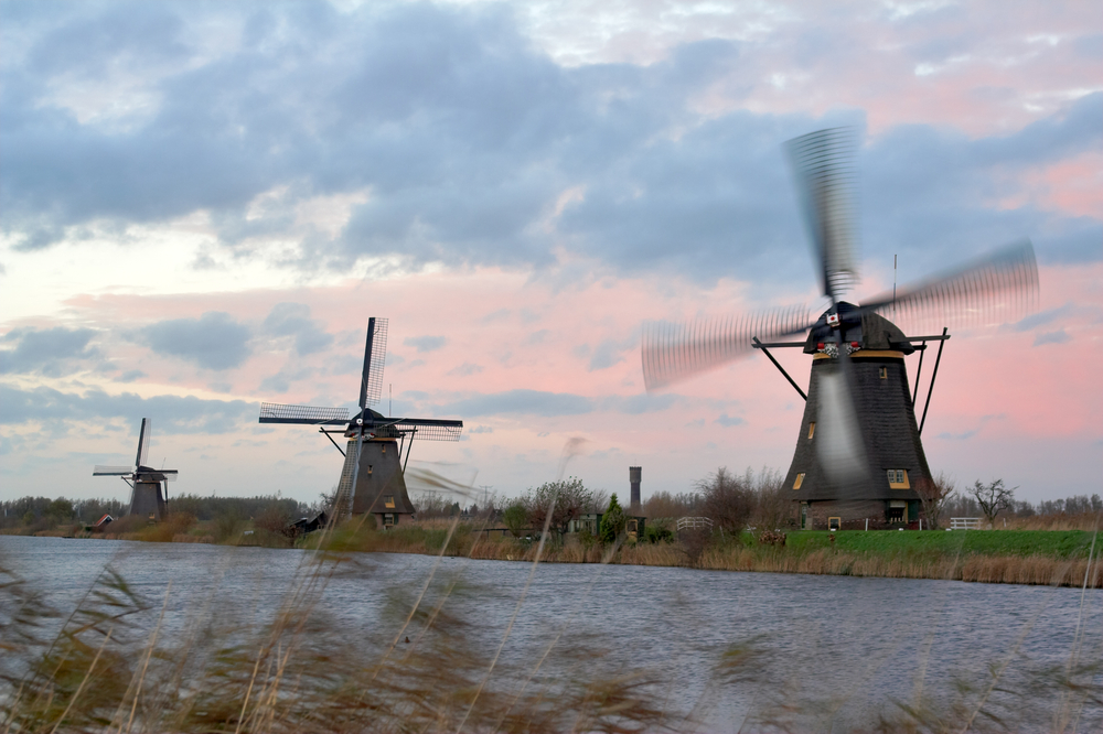 photo-of-windmills-turning-on-cool-day-with-wind-and-clouds
