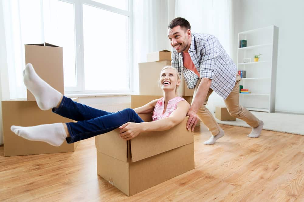 photo-of-man-pushing-girlfriend-in-box-excitedly-in-bright-room-after-winning-bid-on-house-netherlands