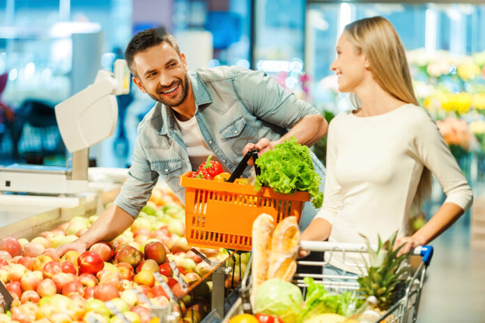 photo-of-couple-flirting-in-supermarket-while-shopping