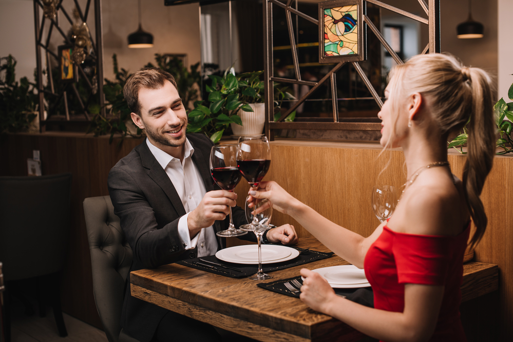 Dutch-couple-having-dinner-at-restaurant-making-a-toast-with-wine-on-Valentines-Day