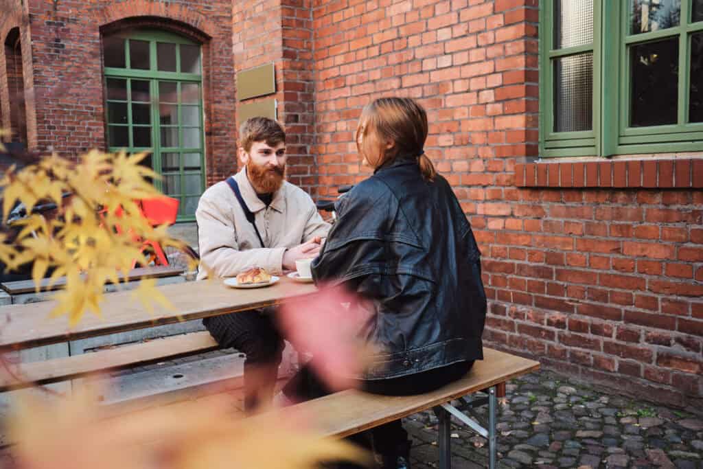 man-and-a-woman-sitting-at-an-outdoor-cafe-in-the-netherlands-on-their-travels