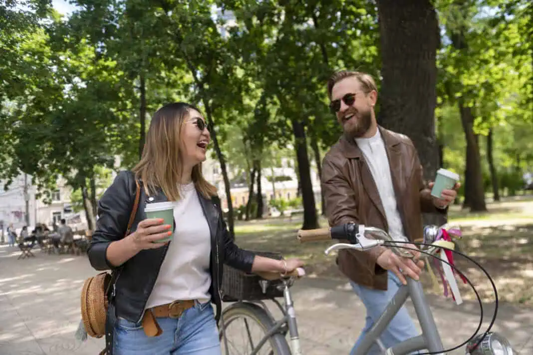 couple-wheeling-their-bikes-and-drinking-coffee-after-moving-to-the-netherlands-for-love