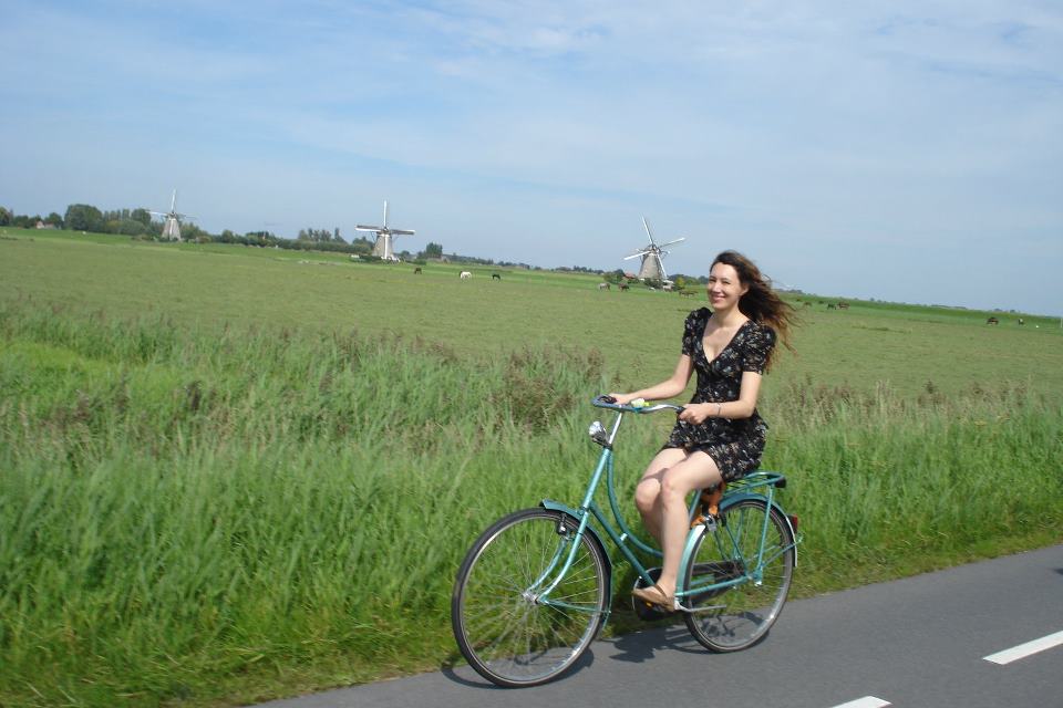 photo-author-cycling-on-dutch-road-with-windmills-in-background
