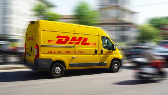 A-yellow-DHL-courier-service-delivery-van-speeding-through-busy-streets-against-blurred-background