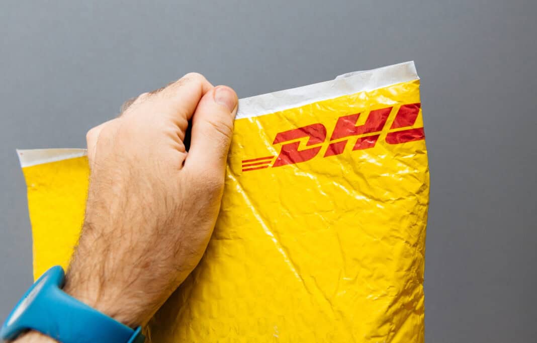 photo-of-hand-holding-up-Dhl-package