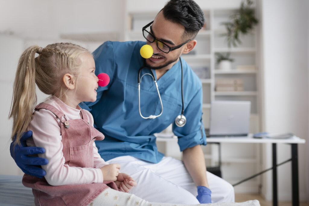Pediatrician-in-the-Netherlands-helping-a-girl-both-wearing-clown-noses