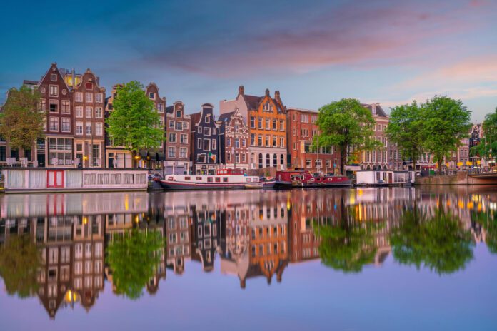 Amsterdam-city-skyline-with-water-in-sunset