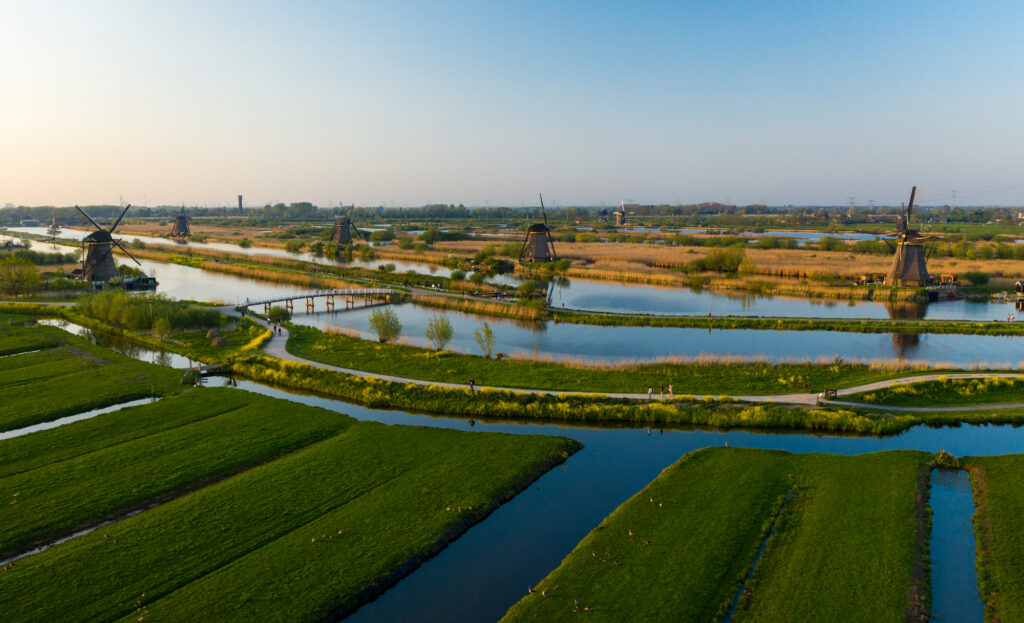 drone-photo-of-flat-dutch-landscape-with-canals-and-windmills