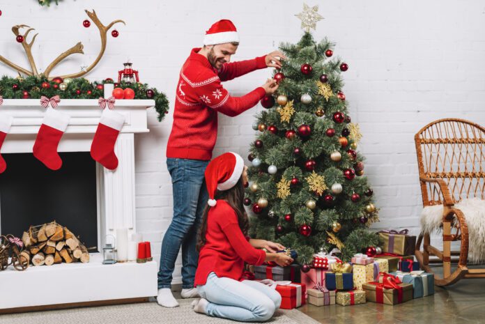 dutch-couple-decorating-christmas-tree-with-ornaments
