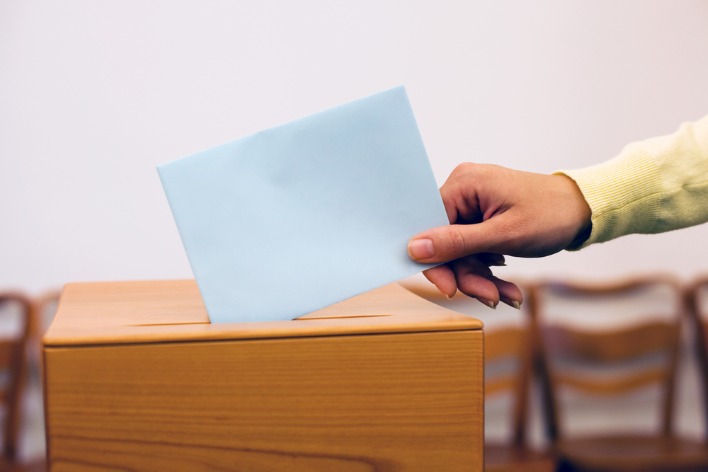 a-young-woman-gives-off-in-an-election-vote-ballot-at-the-polling-station