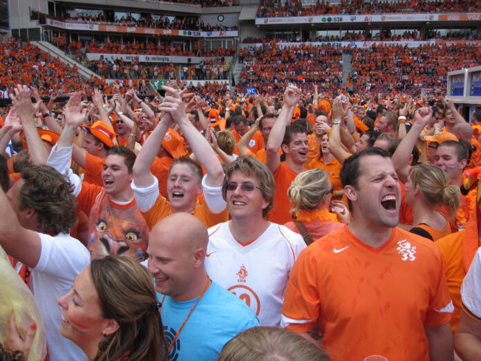 photo-of-dutch-fans-at-football-match-dressed-in-orange-celebrating