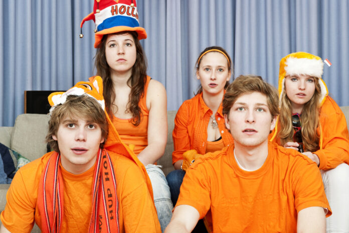 photo-of-five-dutch-football-fans-wearing-orange-looking-disappointed