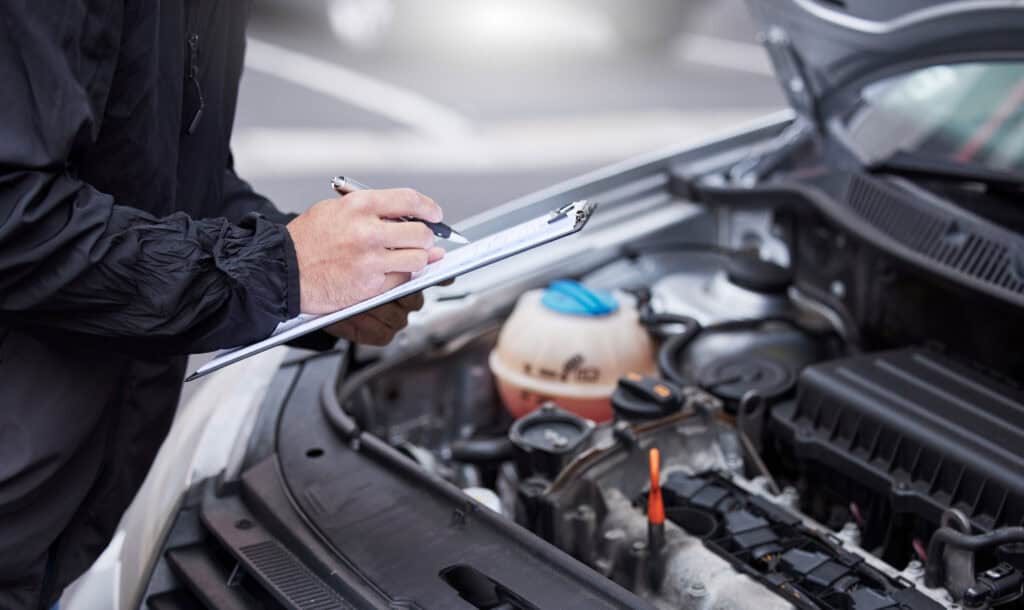dutch-mechanic-checks-clipboard-as-he-conducts-periodic-motor-vehicle-test-apk