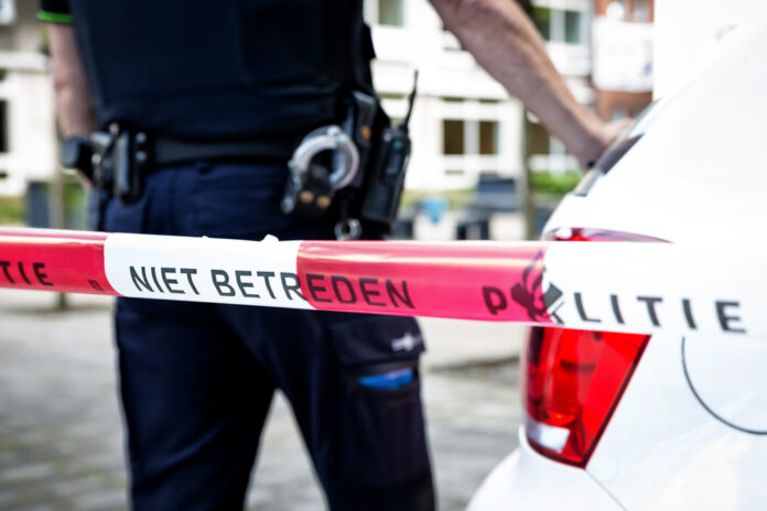 a-picture-of-a-dutch-police-officer-standing-behind-tape