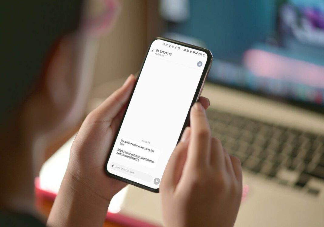 photo-of-a-hand-holding-a-smartphone-with-a-scam-message