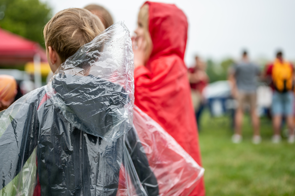 Young-child-with-a-clear-plastic-poncho-to-keep-off-the-rain-at-a-football-game-ready-to-face-dutch-rain