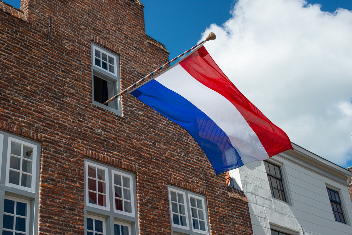 Dutch-flag-flying-out-of-a-dutch-house