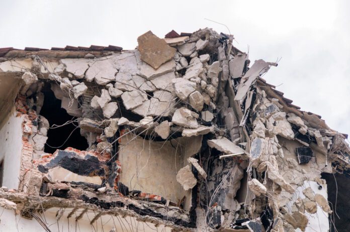 rubble-of-collapsed-building-due-to-earth-quake-with-exposed-bricks-and-tree-twigs