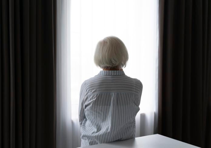 elderly-woman-staring-out-of-window