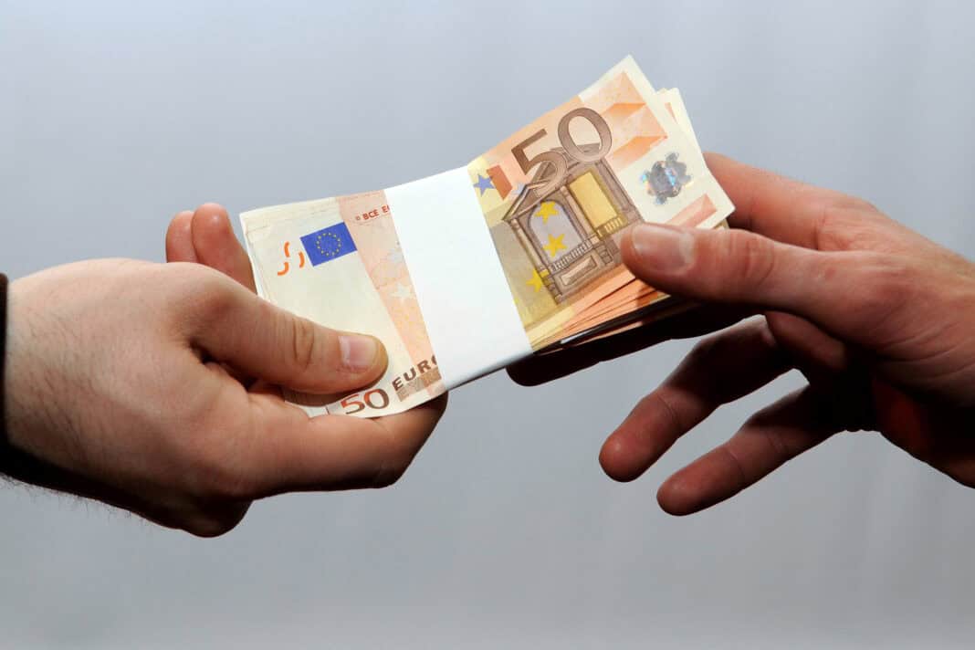 euros-being-handed-from-one-person-to-another