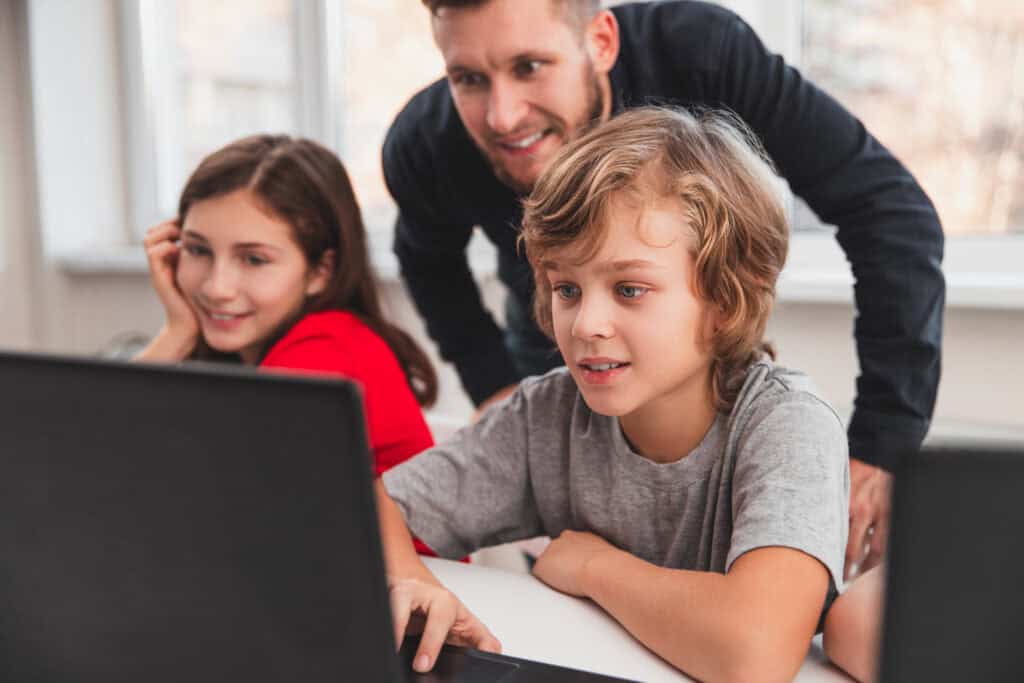 photo-of-father-and-tweens-with-laptops-learning-about-online-security-in-the-netherlands