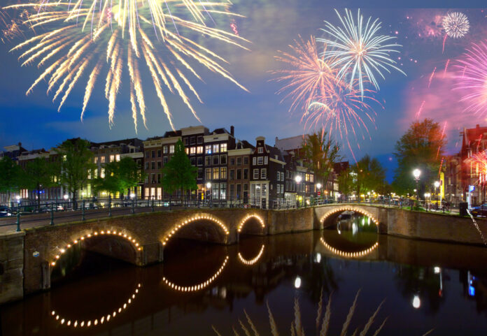 photo-of-a-firework-display-above-the-canal-houses-in-amsterdam